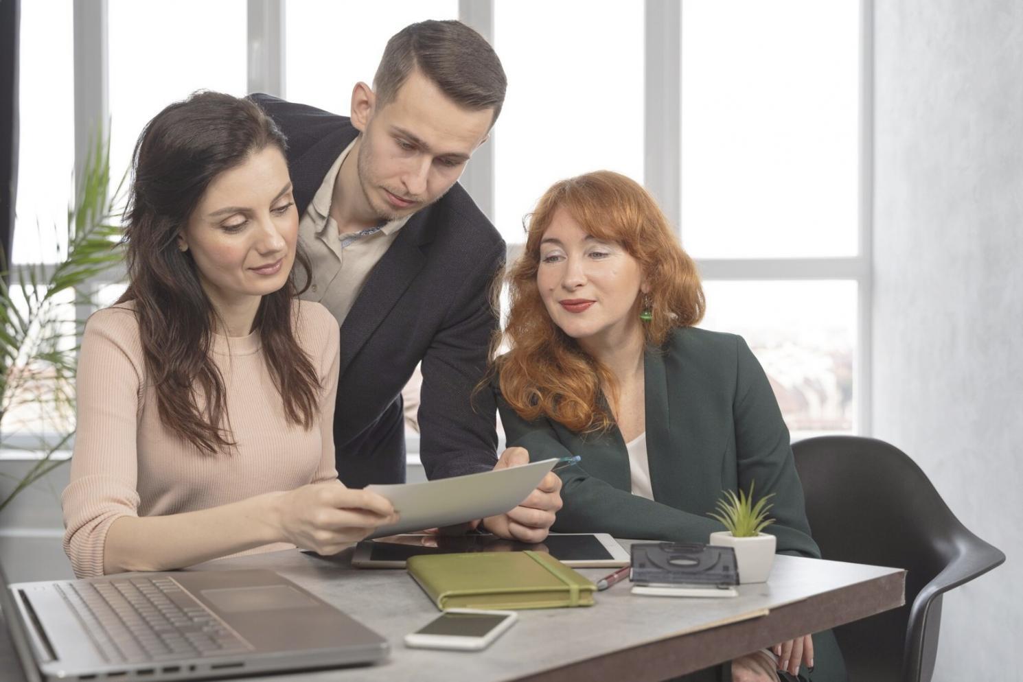 Students collaborating on investment portfolio analysis during group session